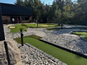 Faux sand traps, sloping terrain and varying turf are typical of AGS Modular Advantage mini golf courses