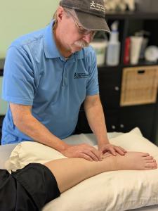 Kevin Rebman, in a treatment session focusing on scar tissue and soft tissue mobility following surgery.