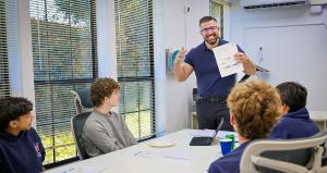 Instructional classroom setting featuring students and Olympus College Prep Founder and Director Aydin Mehrage