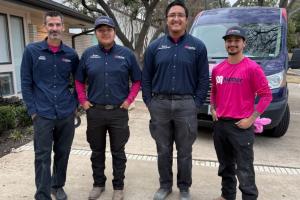 4 uniformed plumbers from Mother Modern Plumbing stand outside Preston Hollow, TX home