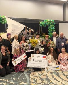 Winners, organizers, and supporters pose together following the 2026 Gateway to the Americas Cup International Floral Design Competition awards ceremony in Orlando, Florida.