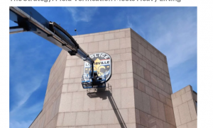 Louisville Metro Police Department badge sign installation on four-story headquarters building
