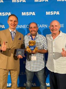 Jeno Zsiga, General Manager for BARE Europe, Jason Bare, President, and Mike Bare, CEO accept recognition among the MSPA Europe/Africa Elite Status for 2026