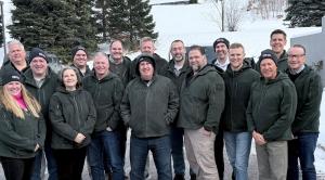 Scott Hoffman President and CEO center surrounded by Fisher Barton leadership team