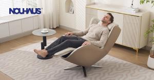 A man relaxing with his eyes closed in a bright living room on the NOUHAUS Aurora zero gravity full-body massage chair, enjoying a comfortable therapeutic experience.