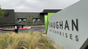 A picture of Vaughan Enterprises (Vaughan Automotive) in Boerne, TX with landscaping and a United States flag.