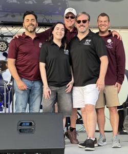 A group of people, including members of Delta Kappa Kappa Fraternity and the Child Advocacy Center of Oswego County, gather during DKK’s Centennial celebration and fundraising effort benefiting the CAC