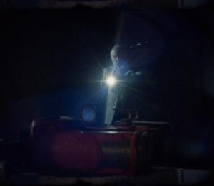 Man searches a darkened warehouse for clues about a missing girl