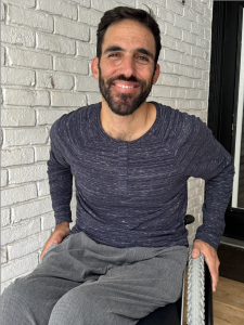 Eron Zehavi, Entrepreneur and Transformational Coach, sitting in a wheelchair