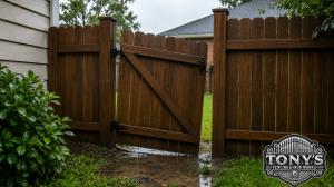 Wood fence gate slightly sagging after heavy rain in Southeast Louisiana yard