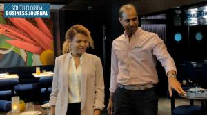 Virgin Voyages CEO Nirmal Saverimuttu walks through Rojo, a Spanish restaurant aboard the cruise ship Brilliant Lady, with South Florida Business Journal reporter Cortney Danielle Moore.