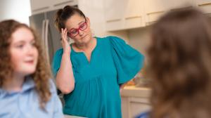 A 50 year old mum suffering back pain and poor mental health as a result of the mental load of raising kids, working and managing the house.