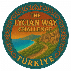 Circular logo for The Lycian Way Challenge featuring a coastal landscape with ancient cliff tombs, framed by an ornate teal border with the text "THE LYCIAN WAY CHALLENGE" and "TÜRKIYE" in gold.