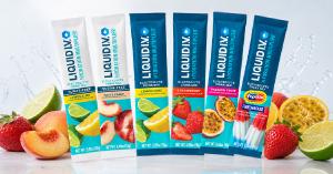 Six Liquid I.V. Hydration Multiplier electrolyte drink mix stick packets displayed in a fan arrangement, including Sugar-Free Lemon Lime, Sugar-Free White Peach, Lemon Lime, Strawberry, Passion Fruit, and Popsicle Firecracker flavors, surrounded by fresh