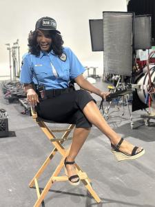 Tanjareen Thomas sits in a director's chair behind the scenes of BET's new series LOT PATROL