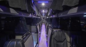 Photo of interior of a Napaway UltraLiner motorcoach, looking down the aisle. Showing 16 Butterfly Flexible Suites and 11 Bunks