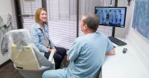 Scottsdale dentist Dr. Alex Martin explaining finance options for dental implants procedure to patient