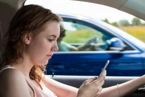 Woman on her phone while driving.