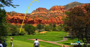 Golfer teeing off at Oakcreek Country Club in Sedona, Arizona, with a yellow ReelGOLF shot trace arc overlaid on the image showing the ball's flight path against red rock canyon formations and a bright blue sky.