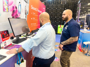 Visitors experiencing directional audio technology at the Audfly booth