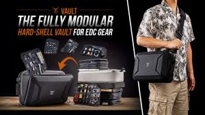 VAULT Basecamp organizer displayed with multiple removable gear pages, stacked modules, and a shoulder carry setup.