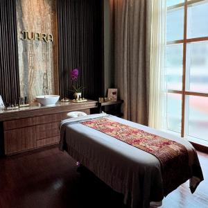 A photo of a spa treatment bed with the JUARA logo on the wall.