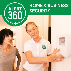 Rep and Customer Going Over Home Security Panel