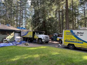 Cloise & Mike Construction Inc. roofing crews and company vehicles at a residential roofing project in Kitsap County, Washington.