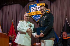 U.S. Marine Corps Maj. Nickolas Mohr is congratulated by U.S. Navy Rear Adm. Michael S. Mattis during graduation from NPS, Mohr is now applying his master's education in AI to develop an enhanced analytics tool for logistics decision-making.