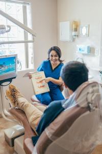Dental hygienist explaining what to expect during root canal procedure at Prime Dental