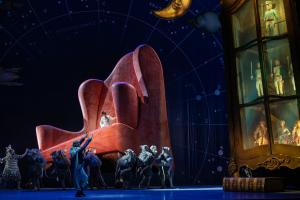 Atlanta Ballet Presents "The Nutcracker." This image shows the scale and spectacle of the show with an ensemble of tiny dancers at the base of a multi-story chair and curio.