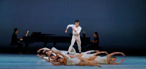 As part of Atlanta Ballet's "Balanchine & Peck" mixed-repertory program, eight soloist dancers in the ensemble shift into shapes and formations in front of an accompanying piano.