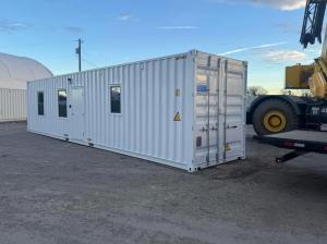 IMAGE OF A WHITE CONTAINERIZED MOBILE OFFICE ON A JOBSITE
