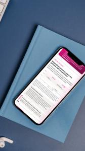Fully optimised for all devices "The Last Dial Tone" shown on a smartphone on top of a notepad