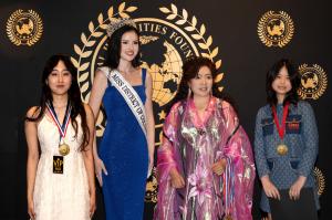 Young artists Chunti Yang and Emily Du receive awards from Allison LaForce (Miss District of Columbia USA 2025) and Bella Yanbo Huang, Founder of the Global Youth Art Competition, during the Global Youth Art Competition & Exhibition at the Kennedy Center.
