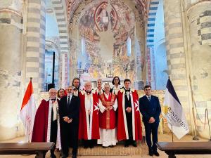 Participants at a Saint John feast celebration inside the historic Abbazia di Santa Giustina in Sezzadio, Italy.