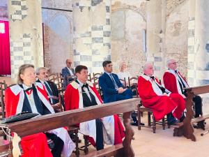 Participants seated during a Holy Mass at the Abbazia di Santa Giustina in Sezzadio, Italy.