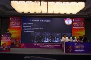 Dr. Mohana Rao Patibandla presenting common indications for stereotactic radiosurgery at YNFCON 2026 Mumbai, including brain metastases, vestibular schwannoma, meningioma, AVMs, trigeminal neuralgia, and pituitary adenoma.