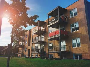 A collection of modern US residential buildings, including condos and contemporary apartment properties, representing urban real estate development.