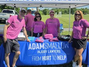 Listed left to right: Adam Smallow, Carolina Hernandez, Michelle Beckwith & Julia Fuller in front of the Adam Smallow Injury Lawyers stand.