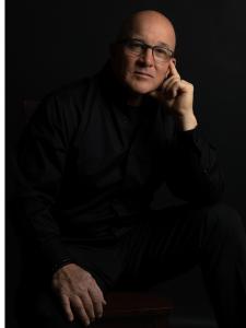 The image features the author of Pay to Play, Stephen L. Keller