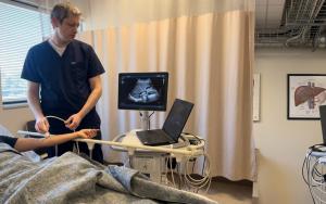Dr. Jacob White performs a diagnostic ultrasound to assess the wrist artery before catheter placement for UFE.