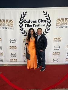 Farrah Mechael and filmmaker Bryan Huynh posing on the red carpet at the Culver City Film Festival.
