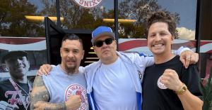 Michael “Coach Mike” Franco, Coach Al Franco, and Daniel “Twitch” Franco standing together outside Warzone Boxing Club in Upland, California.