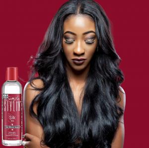 A woman with long, smooth, glossy black hair is shown beside a bottle of Simply Stylin' Silk Serum, a pure silicone hair serum for natural hair, wigs and extensions.