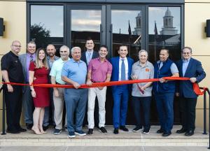 Joseph LaBarbiera and Partners are joined by North Bergen Mayor Nicholas Sacco, Police Chief Robert Farley, and elected Commissioners during the Grand Opening ribbon cutting ceremony.