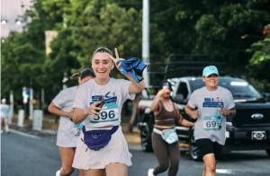 Photo of a woman running with a 5K tshirt that says PaMaRa in Puerto Rico
