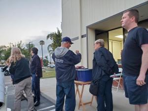 People Looking through telescope and talking at the First Light Party