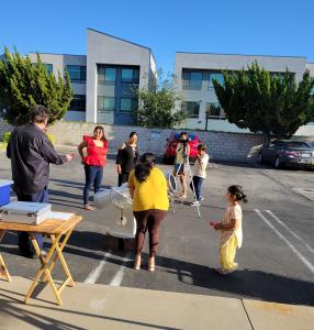 Parents and Kids looking at the Sun during the First Light Party at Simi Computer and IT Solutions