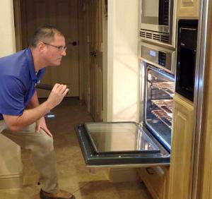 Home Inspector inspecting oven